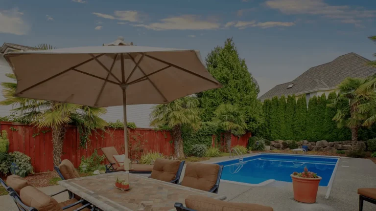Backyard pool area enclosed by a stained wood privacy fence