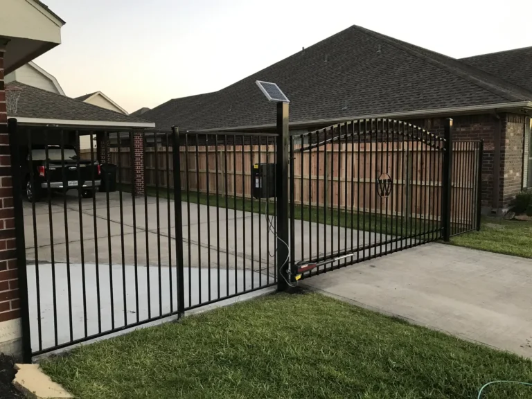 Black iron double driveway gates with an automatic opener