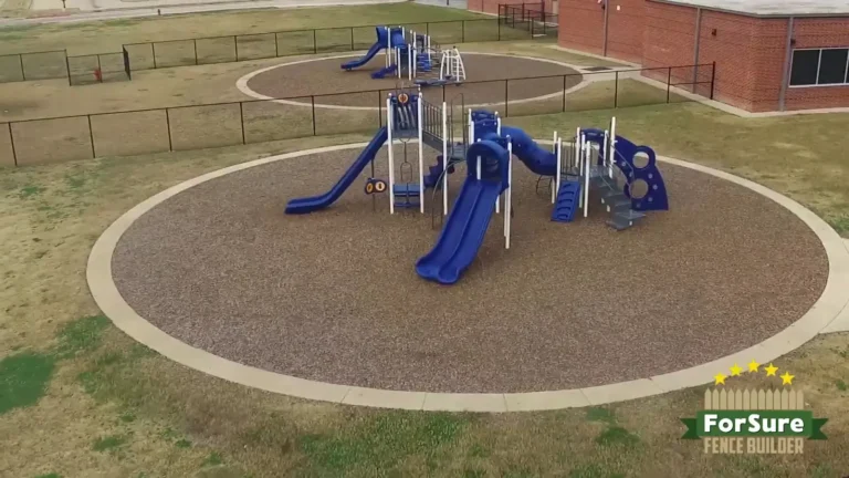 Community playground area enclosed by safety fencing
