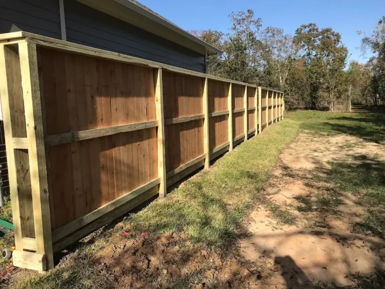 Framed and capped cedar privacy fence along a side yard
