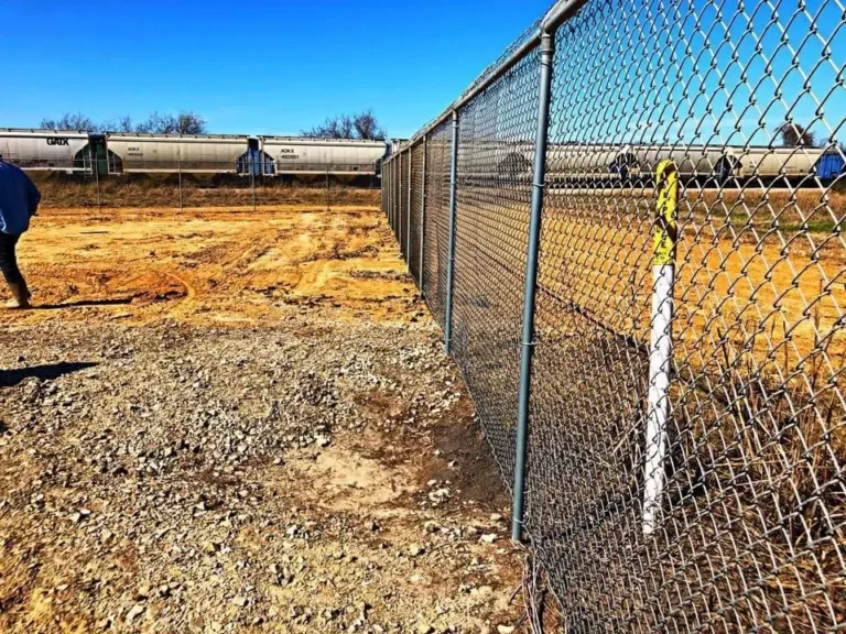 Galvanized chain link fence being installed on a new site