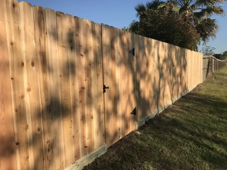 Newly installed cedar privacy fence with straight, even pickets