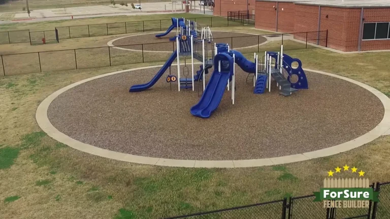 Playground surrounded by black chain link fencing