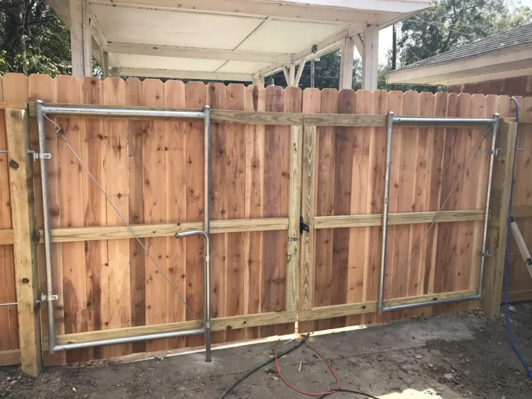 Wide wood double drive gate built on a steel frame to resist sagging