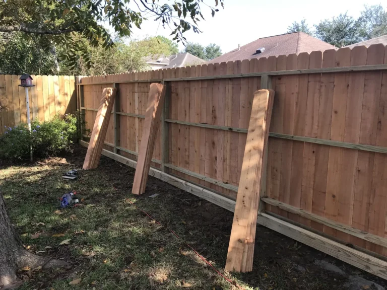 Wood fence repair with temporary bracing while new posts set