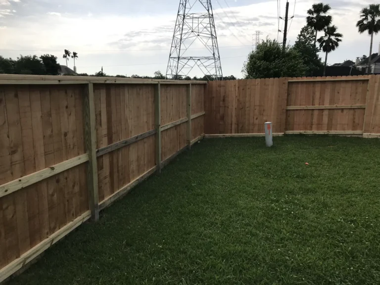 Wood privacy fence turning a corner around a backyard