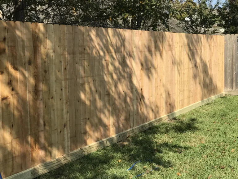 Long run of new wood privacy fence on a residential lot