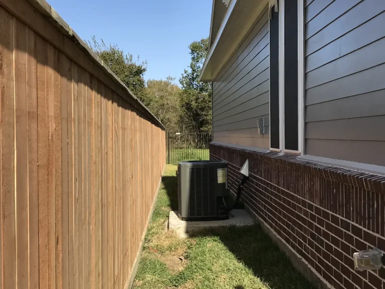 New wood privacy fence along the side of a house