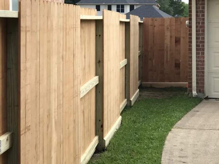 Wood privacy fence and gate along a side yard walkway
